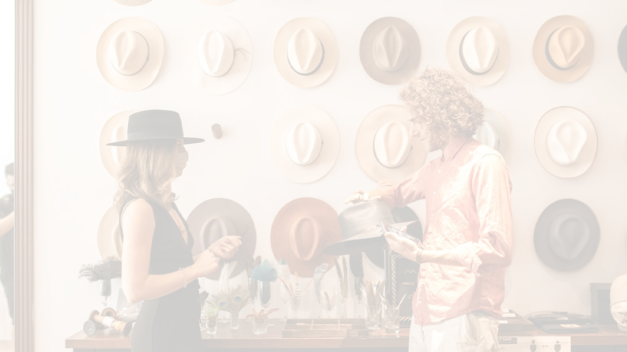 Whitened image of a wall decorated with hats